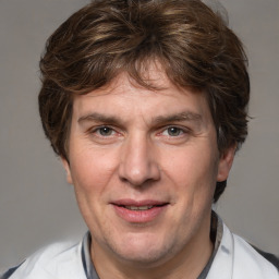 Joyful white adult male with short  brown hair and grey eyes