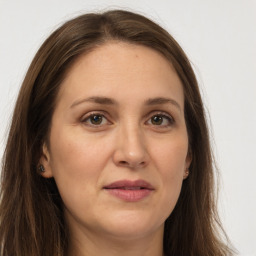 Joyful white adult female with long  brown hair and brown eyes