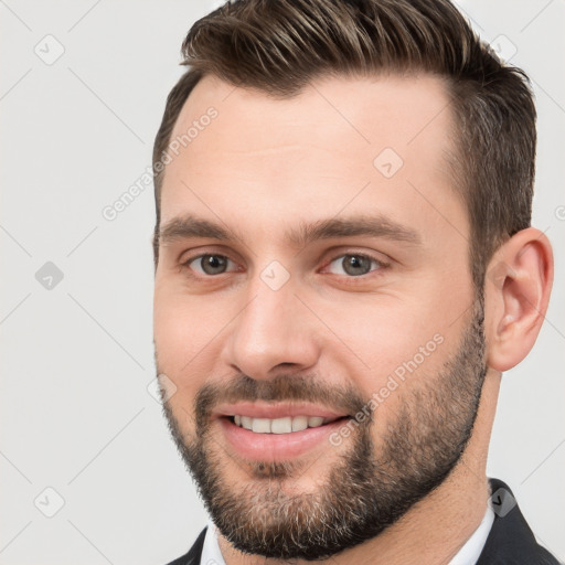 Joyful white young-adult male with short  brown hair and brown eyes