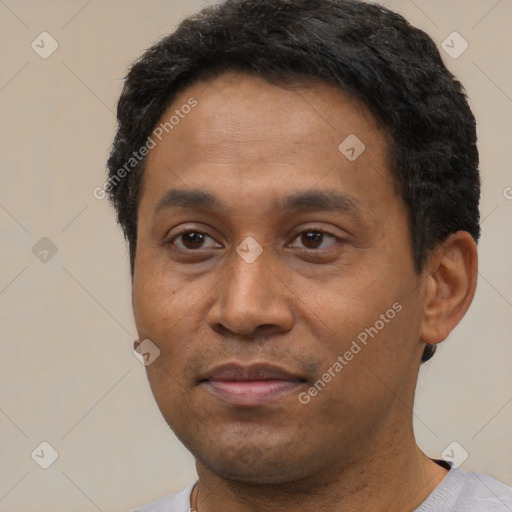 Joyful latino adult male with short  black hair and brown eyes