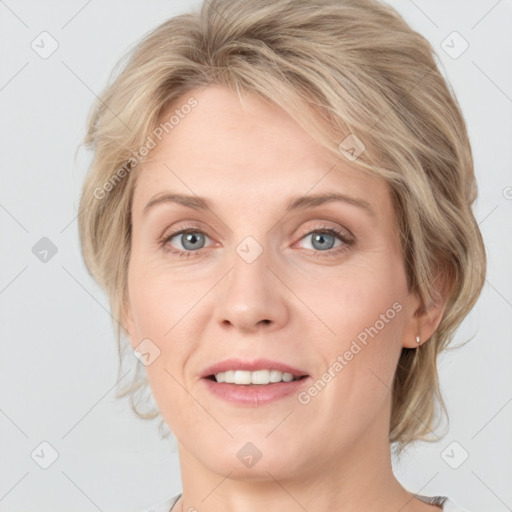 Joyful white adult female with medium  brown hair and green eyes