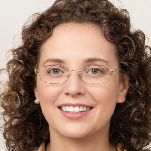 Joyful white young-adult female with medium  brown hair and green eyes