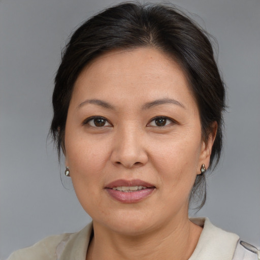 Joyful asian adult female with medium  brown hair and brown eyes