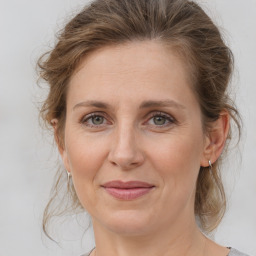 Joyful white adult female with medium  brown hair and grey eyes