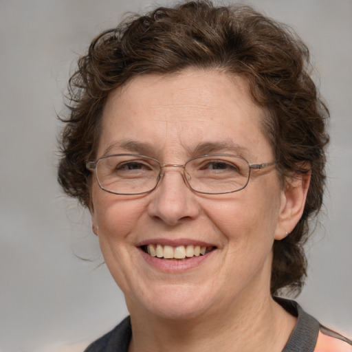 Joyful white middle-aged female with medium  brown hair and blue eyes
