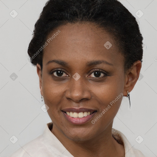 Joyful black young-adult female with short  black hair and brown eyes