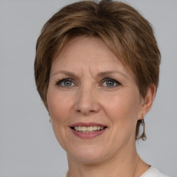 Joyful white adult female with medium  brown hair and grey eyes