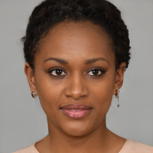 Joyful black young-adult female with short  brown hair and brown eyes