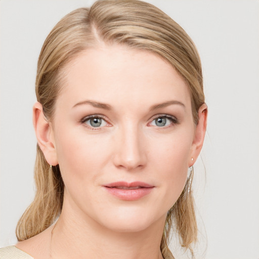 Joyful white young-adult female with medium  brown hair and blue eyes