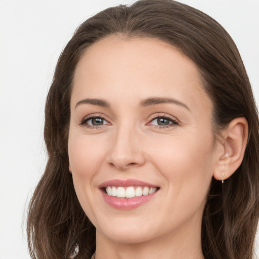 Joyful white young-adult female with long  brown hair and grey eyes