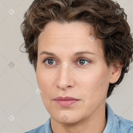 Joyful white adult female with short  brown hair and grey eyes