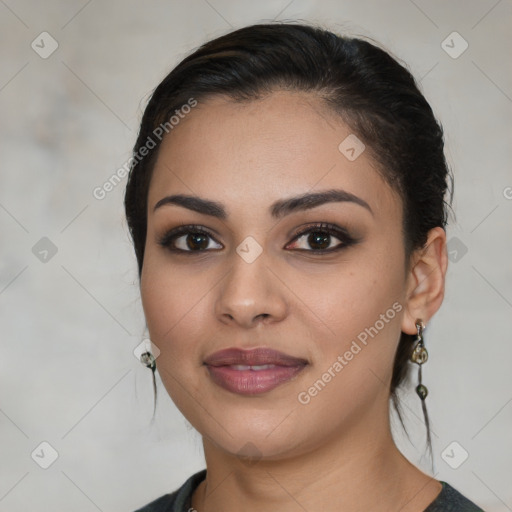 Joyful latino young-adult female with medium  brown hair and brown eyes