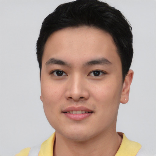 Joyful asian young-adult male with short  black hair and brown eyes
