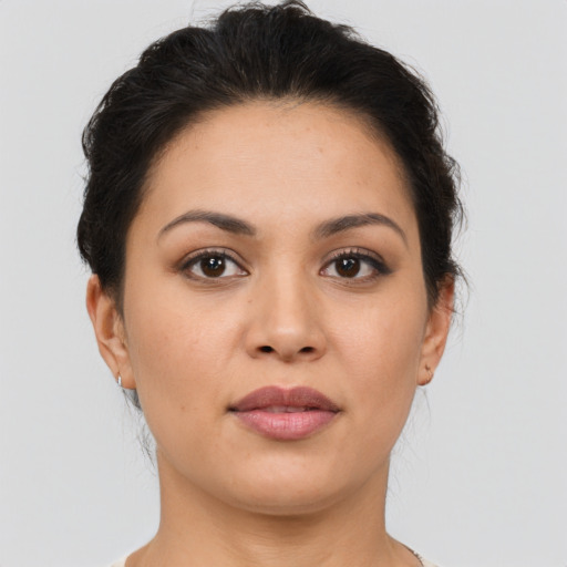 Joyful latino young-adult female with short  brown hair and brown eyes