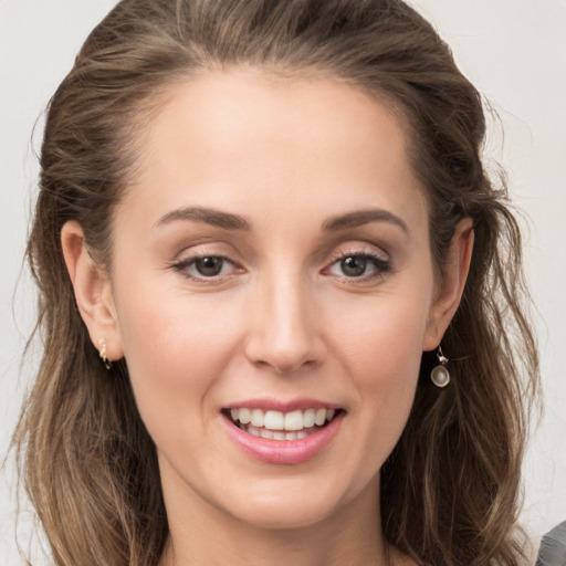 Joyful white young-adult female with long  brown hair and grey eyes