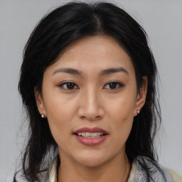 Joyful asian young-adult female with medium  black hair and brown eyes