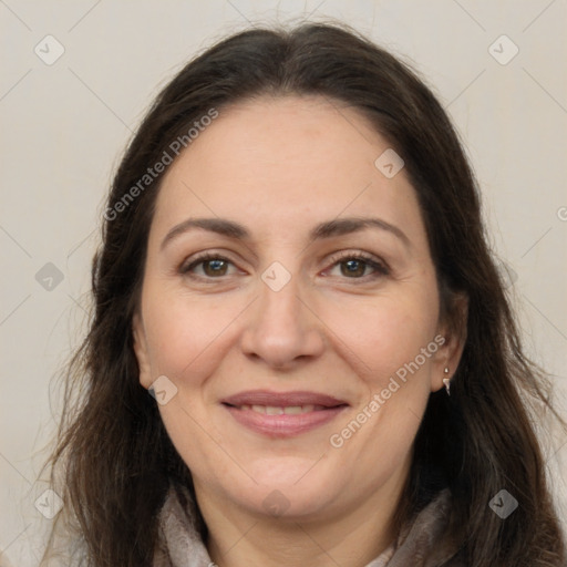 Joyful white adult female with long  brown hair and brown eyes