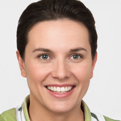 Joyful white young-adult female with short  brown hair and grey eyes