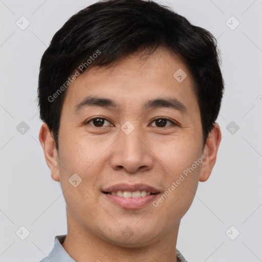 Joyful asian young-adult male with short  brown hair and brown eyes