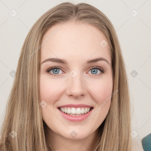 Joyful white young-adult female with long  brown hair and green eyes