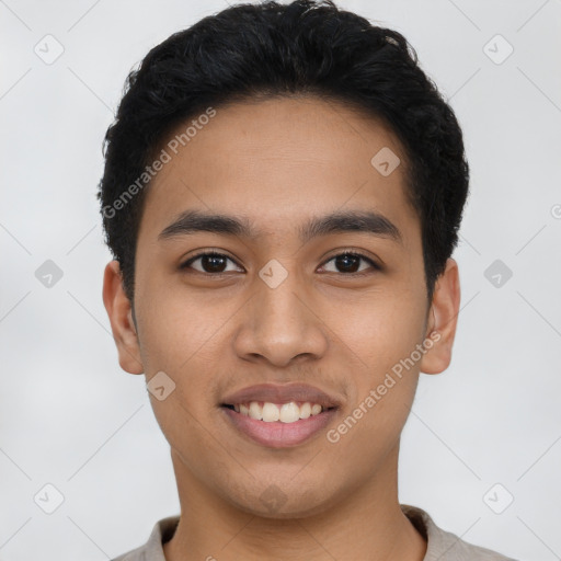 Joyful latino young-adult male with short  black hair and brown eyes