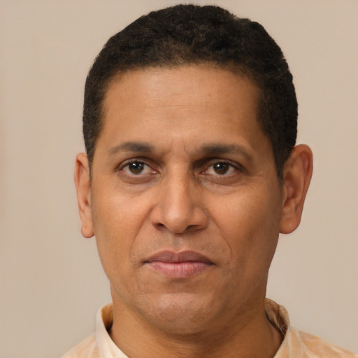Joyful latino adult male with short  brown hair and brown eyes