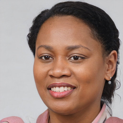 Joyful black young-adult female with medium  brown hair and brown eyes