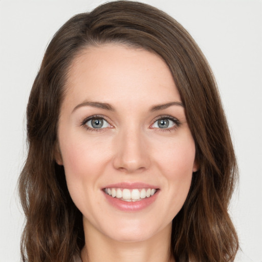 Joyful white young-adult female with long  brown hair and green eyes