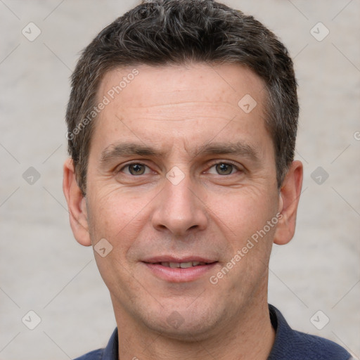 Joyful white adult male with short  brown hair and grey eyes