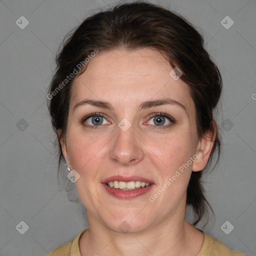 Joyful white adult female with medium  brown hair and blue eyes