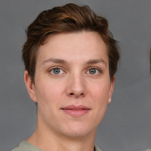 Joyful white young-adult female with short  brown hair and grey eyes