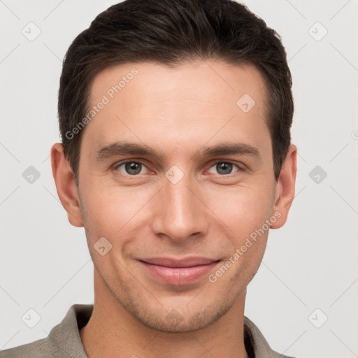 Joyful white young-adult male with short  brown hair and grey eyes