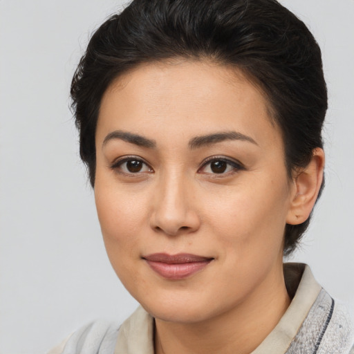Joyful asian young-adult female with short  brown hair and brown eyes
