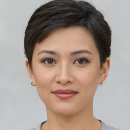 Joyful asian young-adult female with short  brown hair and brown eyes