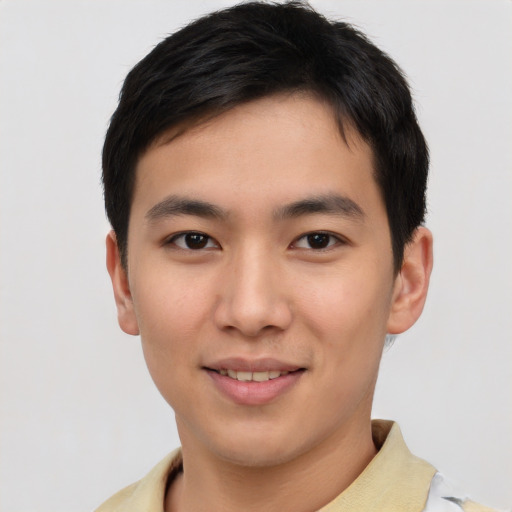 Joyful asian young-adult male with short  brown hair and brown eyes