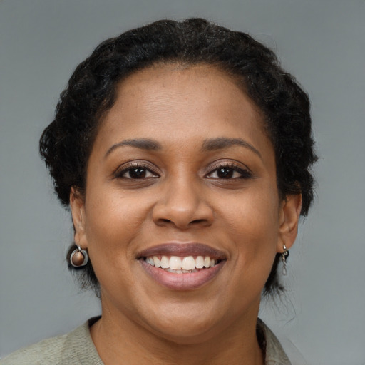 Joyful black young-adult female with medium  brown hair and brown eyes