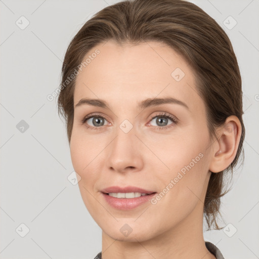 Joyful white young-adult female with medium  brown hair and grey eyes