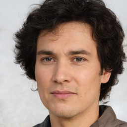 Joyful white young-adult male with medium  brown hair and brown eyes