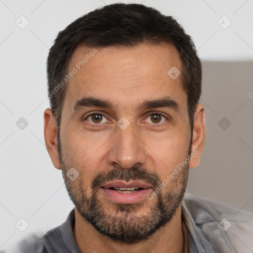 Joyful white adult male with short  black hair and brown eyes