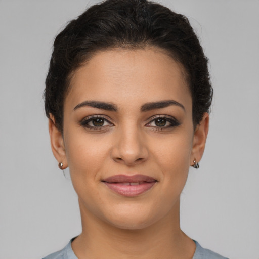 Joyful latino young-adult female with short  brown hair and brown eyes