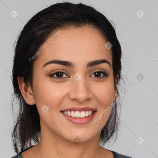 Joyful latino young-adult female with medium  black hair and brown eyes