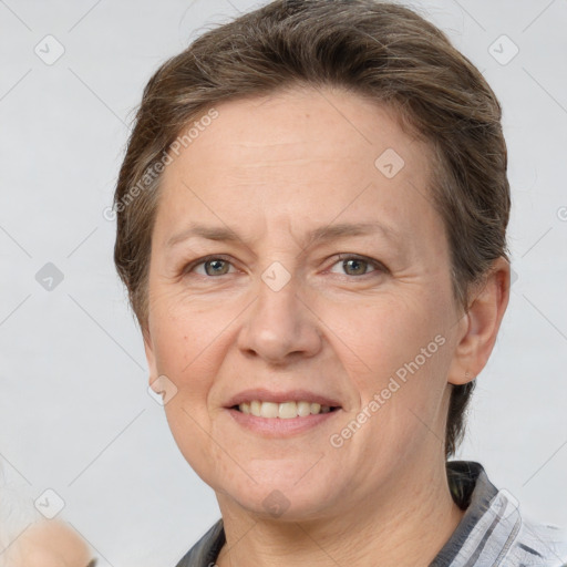 Joyful white adult female with short  brown hair and grey eyes