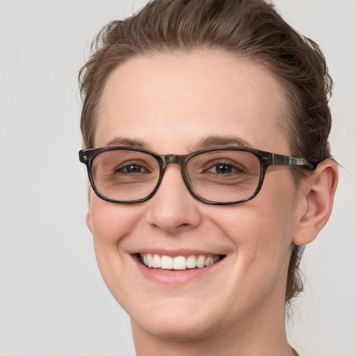 Joyful white young-adult female with short  brown hair and grey eyes