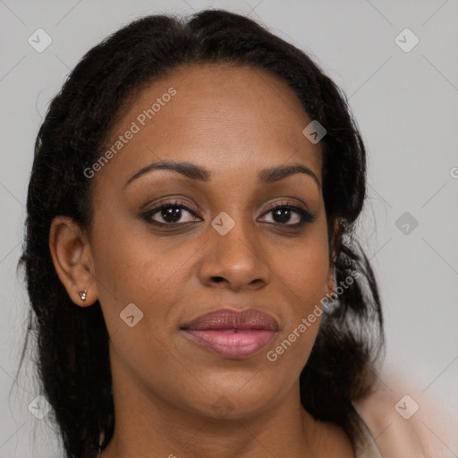 Joyful black young-adult female with long  brown hair and brown eyes