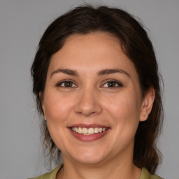 Joyful white adult female with medium  brown hair and brown eyes