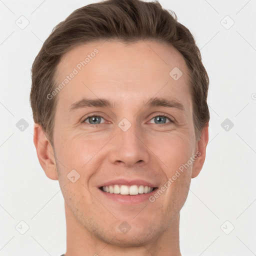 Joyful white young-adult male with short  brown hair and grey eyes