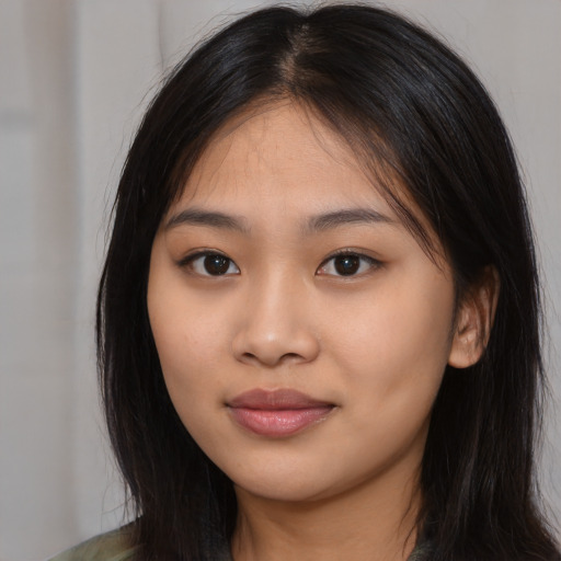 Joyful asian young-adult female with long  brown hair and brown eyes