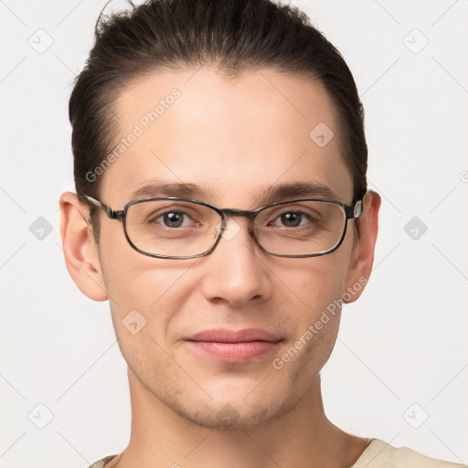 Joyful white young-adult male with short  brown hair and grey eyes