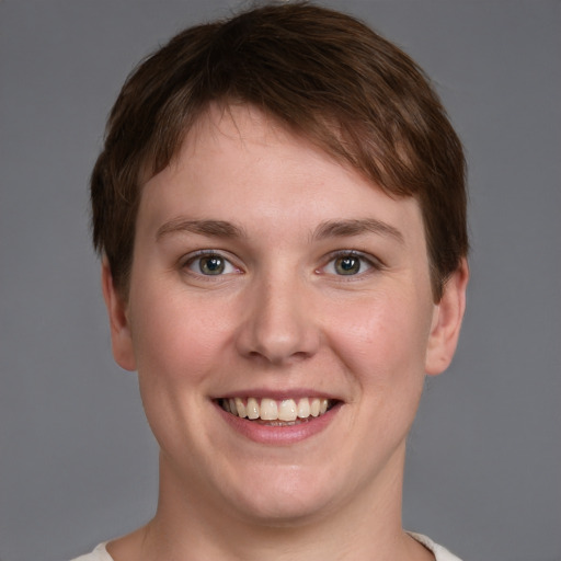 Joyful white young-adult female with short  brown hair and grey eyes