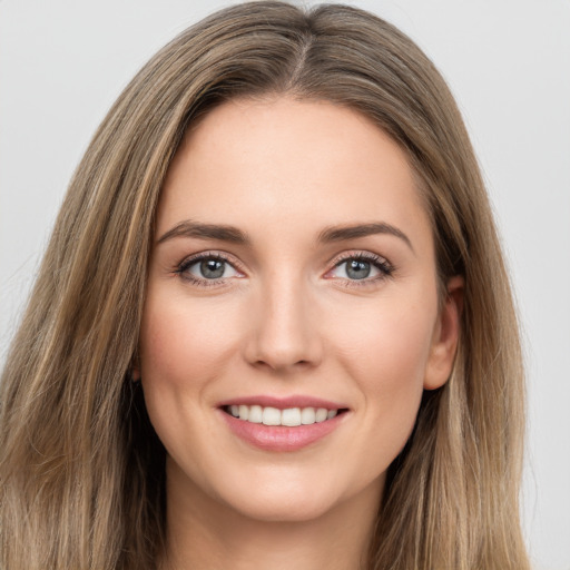 Joyful white young-adult female with long  brown hair and green eyes